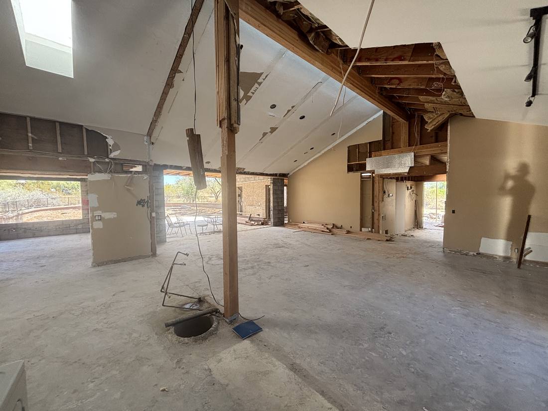 Great room gutted to concrete slab and roof framing