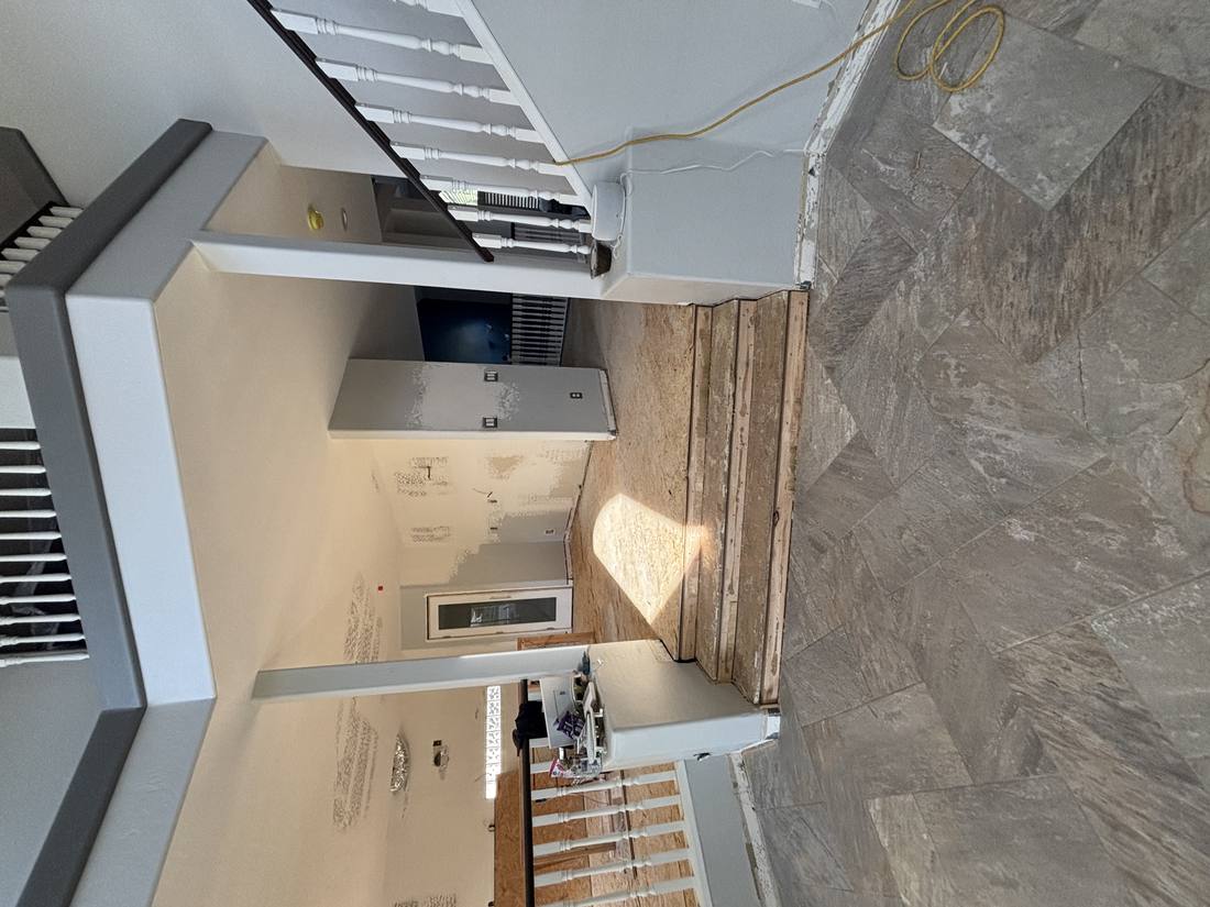 Entryway demolition with stairs and railing exposed